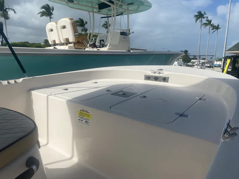 Slide: The Image of 2023 Carolina Skiff 162 JLS boat interior with seating and storage compartments. - 10