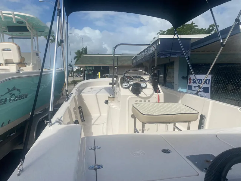 Slide: The Image of 2023 Carolina Skiff 162 JLS boat interior with steering console and seating. - 3