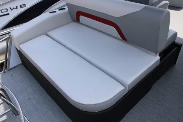 Slide: The Image of 2023 Lowe SS210 DL boat with white cushioned seating and red accent. - 2