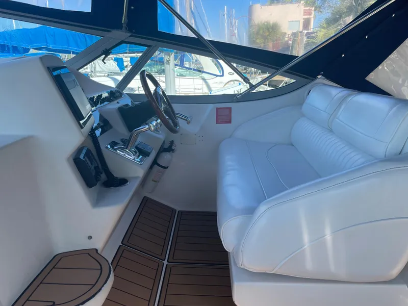Slide: The Image of 1998 Cruisers Yachts 3375 Esprit cockpit with white seating and modern controls. - 10