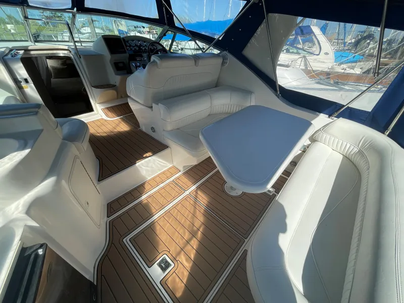 Slide: The Image of 1998 Cruisers Yachts 3375 Esprit interior with white seating and wooden flooring. - 12