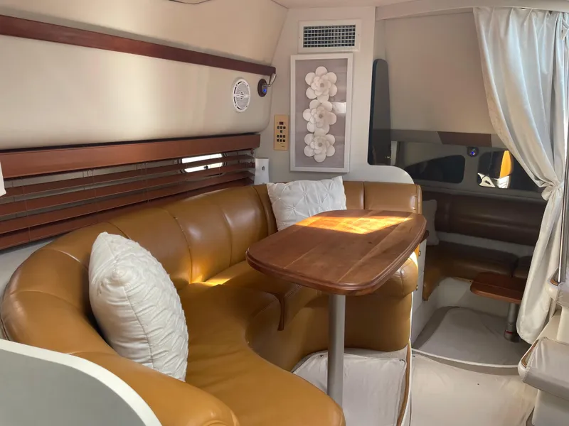 Slide: The Image of Interior of 1998 Cruisers Yachts 3375 Esprit with leather seating and wooden table. - 19
