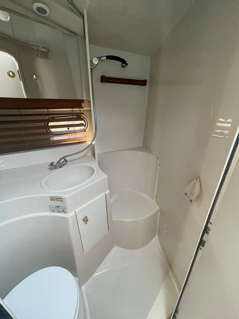 Slide: The Image of 1998 Cruisers Yachts 3375 Esprit bathroom with sink, shower, and toilet. - 28