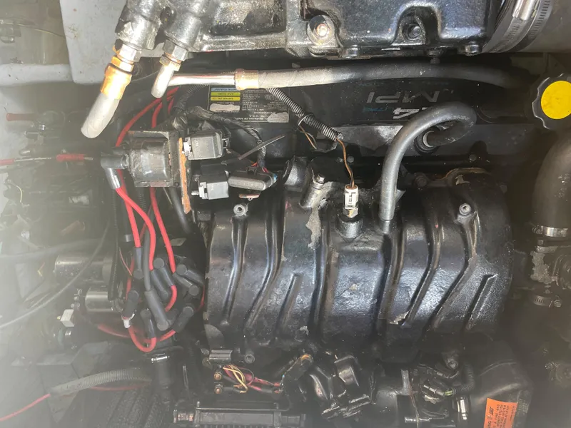 Slide: The Image of Engine compartment of a 1998 Cruisers Yachts 3375 Esprit with visible wiring and components. - 34