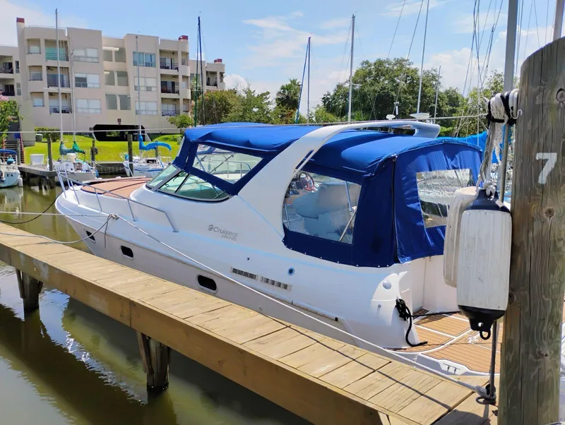 Slide: The Image of 1998 Cruisers Yachts 3375 Esprit docked with blue canopy in marina. - 39