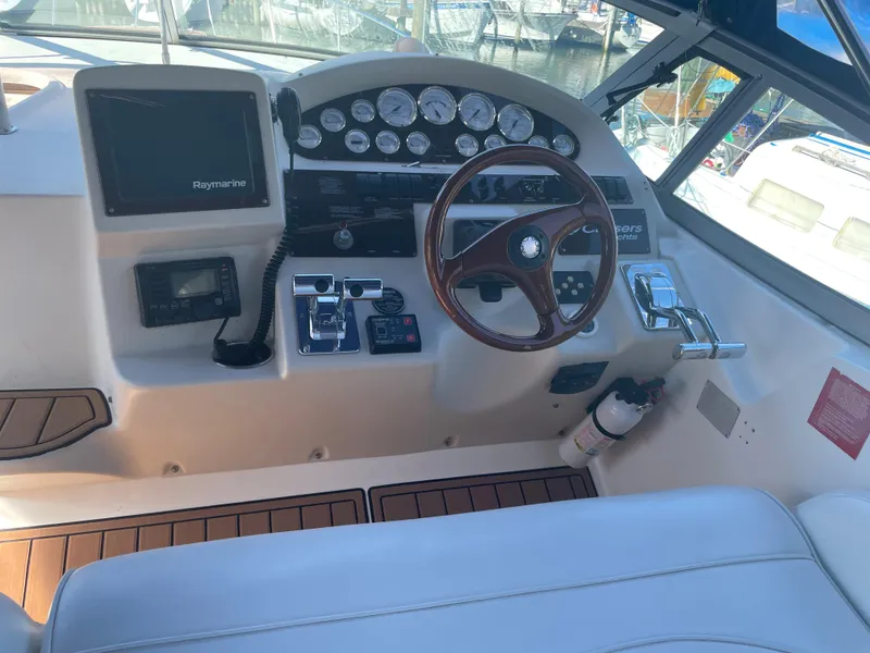 Slide: The Image of 1998 Cruisers Yachts 3375 Esprit helm with steering wheel and navigation instruments. - 9