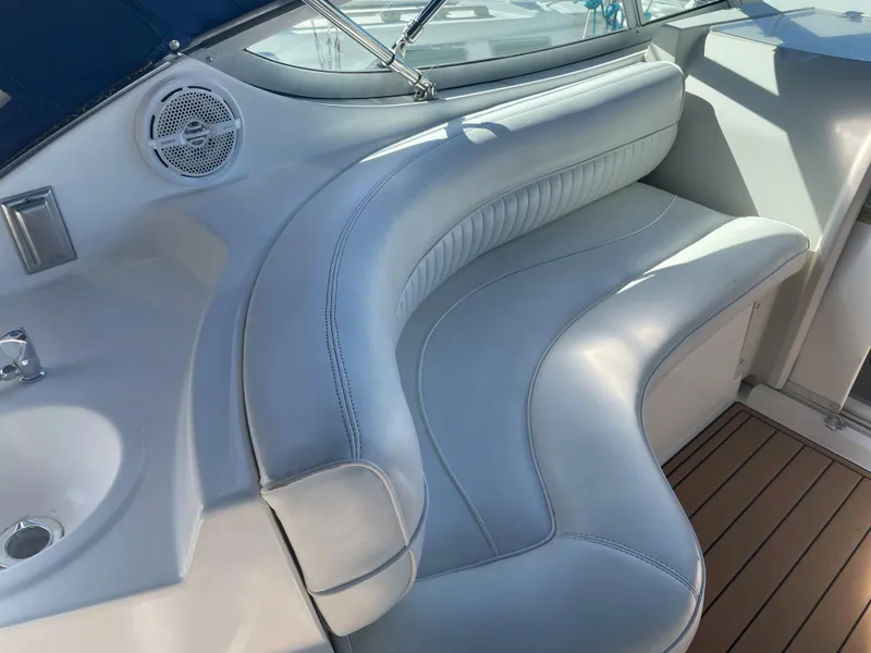 Slide: The Image of 1998 Cruisers Yachts 3375 Esprit interior with curved seating and wood flooring. - 13