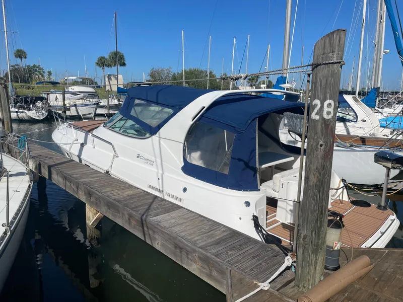 Slide: The Image of 1998 Cruisers Yachts 3375 Esprit docked at marina under clear blue sky. - 2