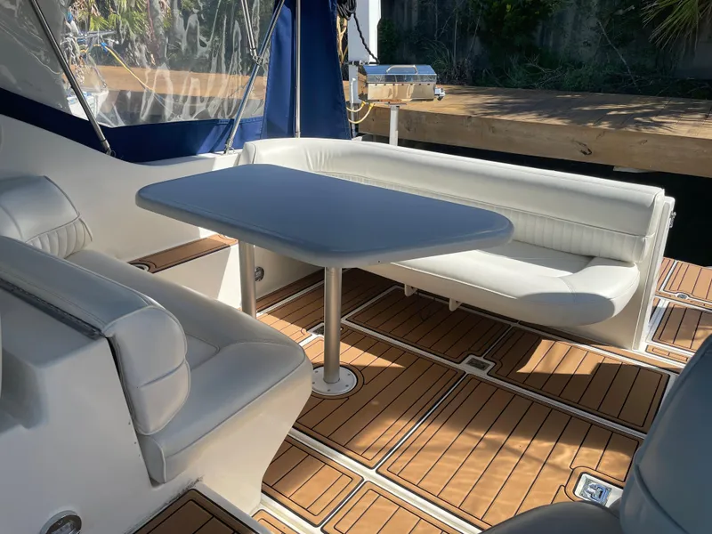Slide: The Image of 1998 Cruisers Yachts 3375 Esprit interior with white seating and wooden flooring. - 21