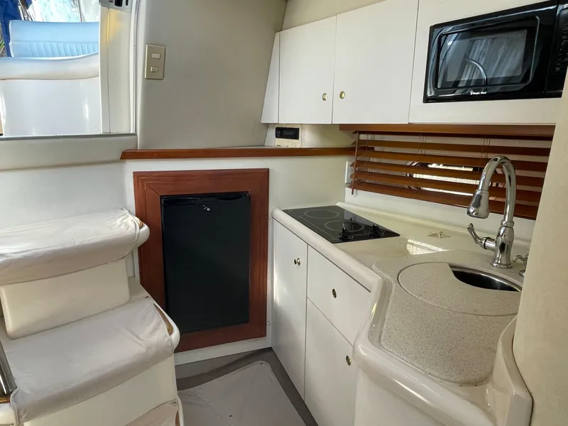 Slide: The Image of 1998 Cruisers Yachts 3375 Esprit kitchen with stove, sink, and microwave. - 26
