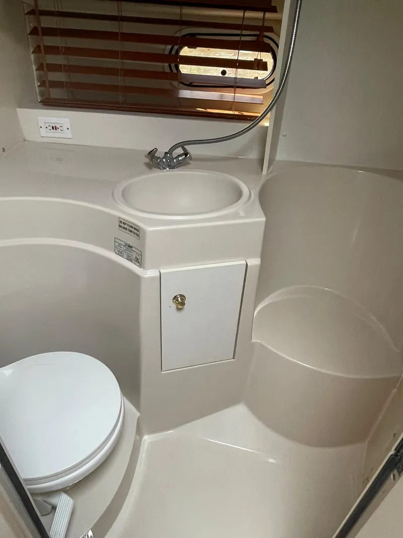 Slide: The Image of 1998 Cruisers Yachts 3375 Esprit bathroom with sink, toilet, and shower. - 27