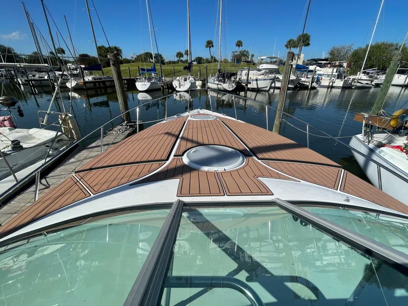 Slide: The Image of 1998 Cruisers Yachts 3375 Esprit docked in a marina, showcasing its sleek deck design. - 30