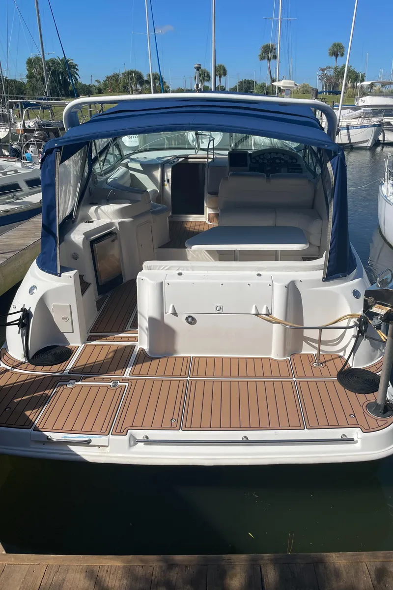 Slide: The Image of 1998 Cruisers Yachts 3375 Esprit docked, featuring spacious deck and seating area. - 31