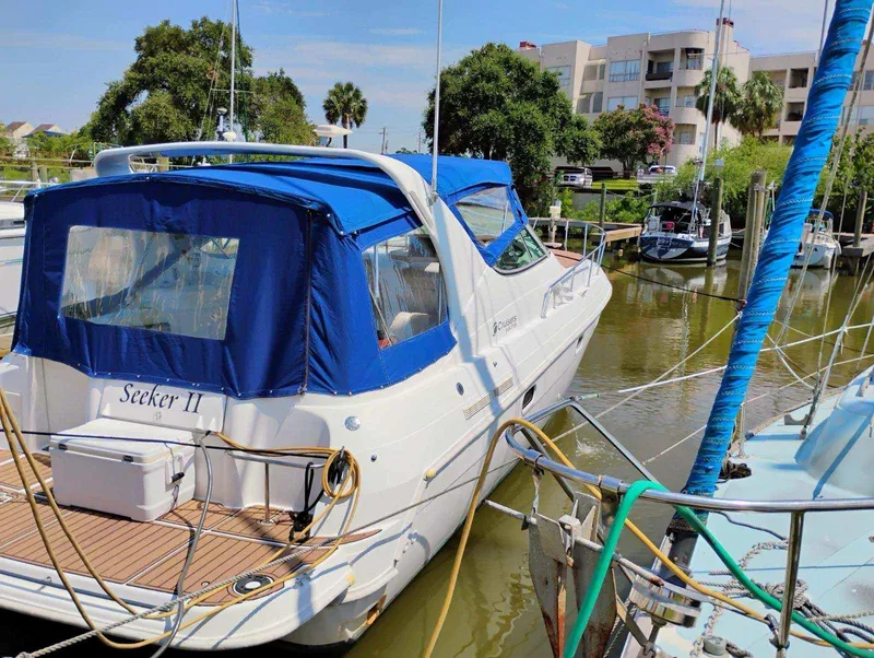 Slide: The Image of 1998 Cruisers Yachts 3375 Esprit docked in a marina with blue canopy. - 37