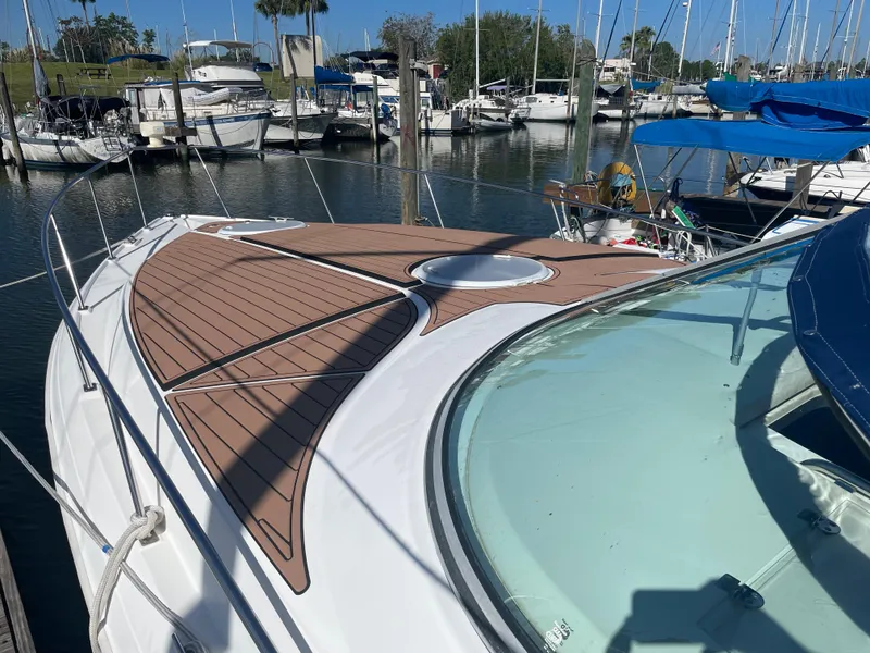 Slide: The Image of 1998 Cruisers Yachts 3375 Esprit docked in marina, featuring sleek deck design. - 4