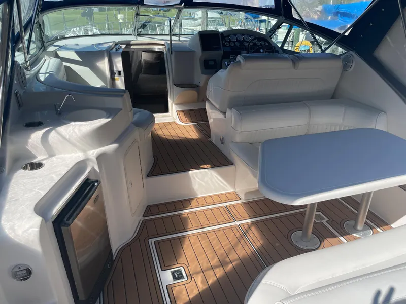 Slide: The Image of 1998 Cruisers Yachts 3375 Esprit interior with seating, table, and kitchenette. - 7