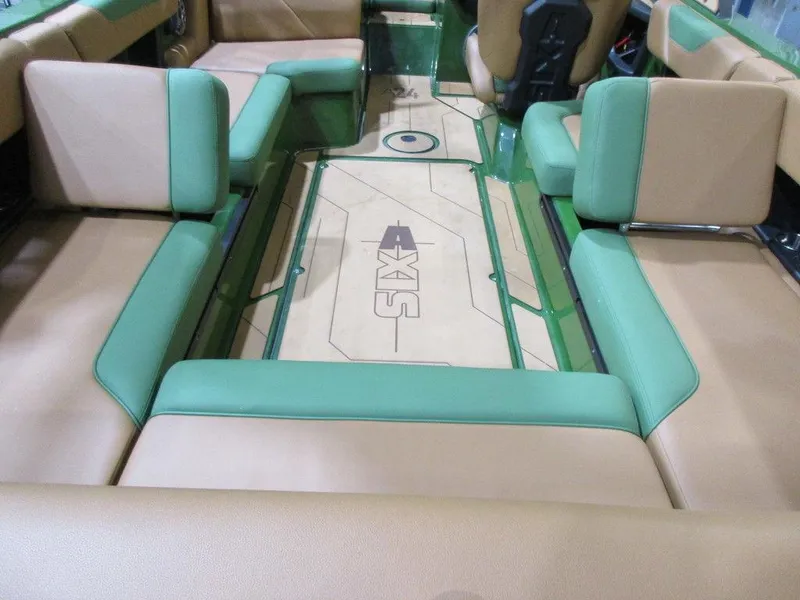 Slide: The Image of 2023 Axis A24 boat interior with green and beige seating. - 12
