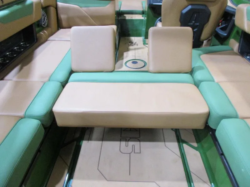 Slide: The Image of 2023 Axis A24 boat interior with green and beige seating. - 13