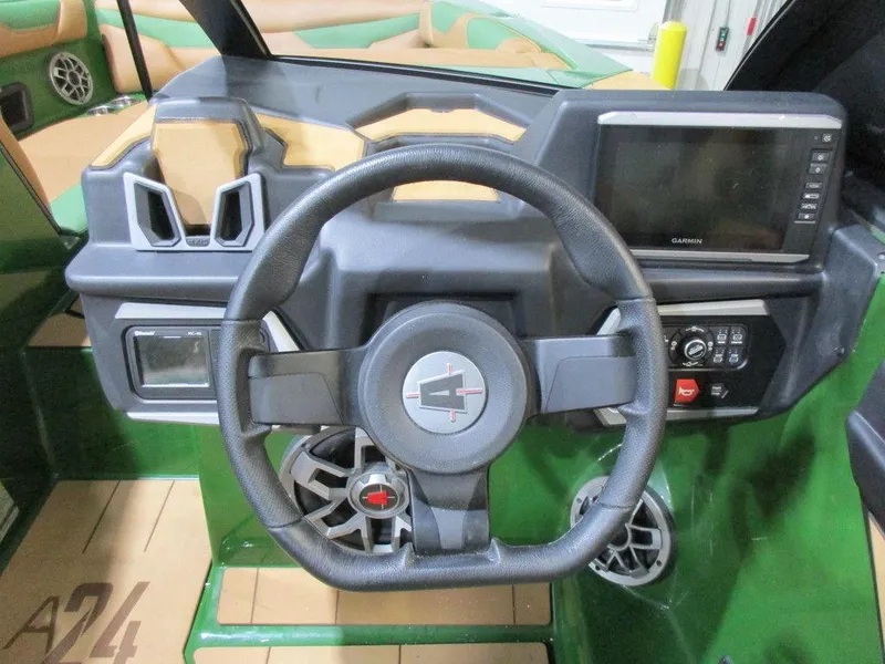 Slide: The Image of 2023 Axis A24 boat dashboard with steering wheel and touchscreen display. - 14