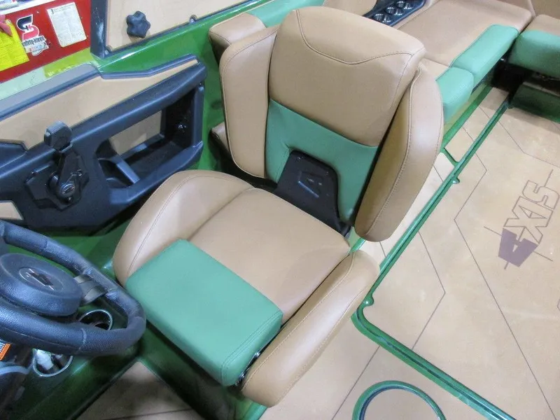 Slide: The Image of 2023 Axis A24 boat interior with tan and green captain's seat. - 15