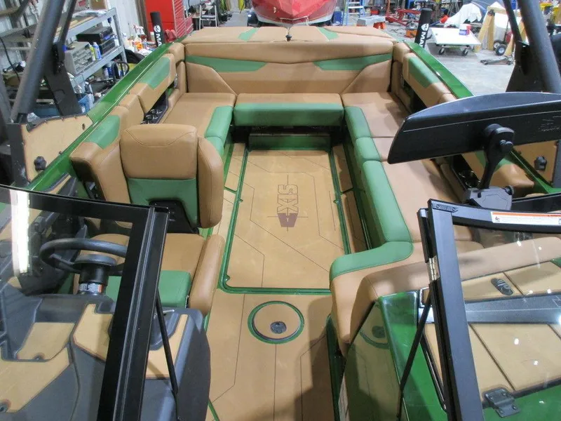 Slide: The Image of 2023 Axis A24 boat interior with tan and green seating. - 16