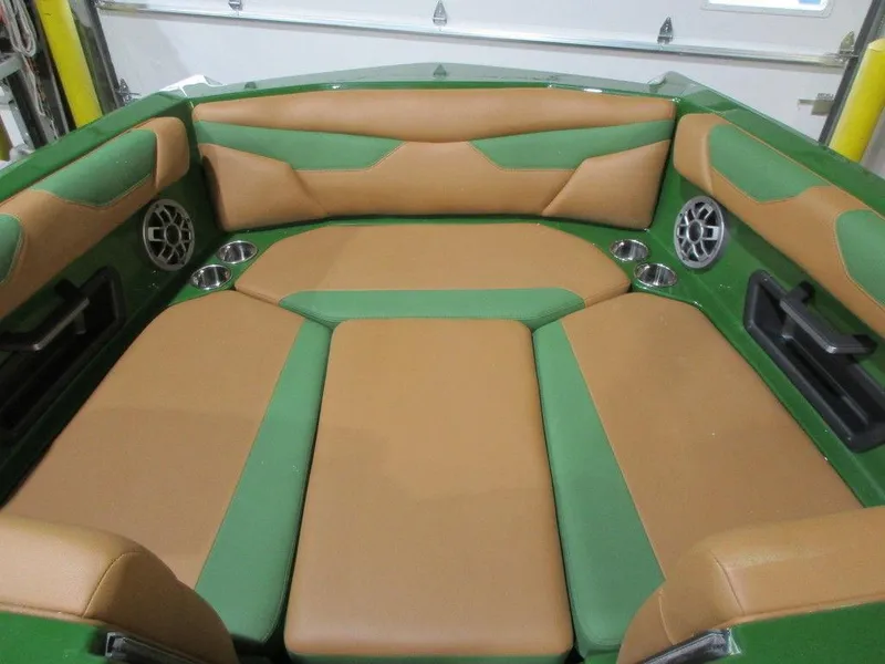 Slide: The Image of 2023 Axis A24 boat interior with green and tan upholstery. - 17