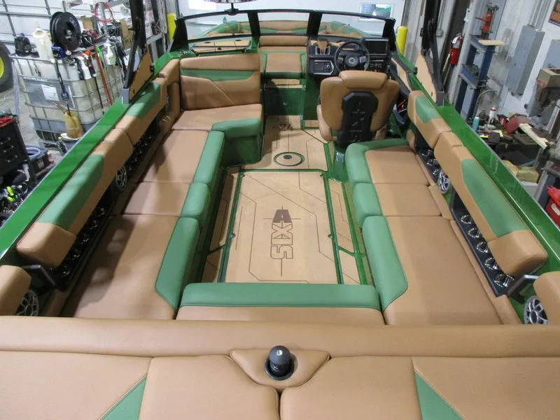Slide: The Image of 2023 Axis A24 boat interior with green and tan seating. - 18