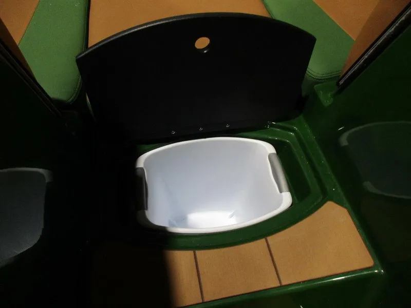 Slide: The Image of 2023 Axis A24 boat storage compartment with a white bin. - 8