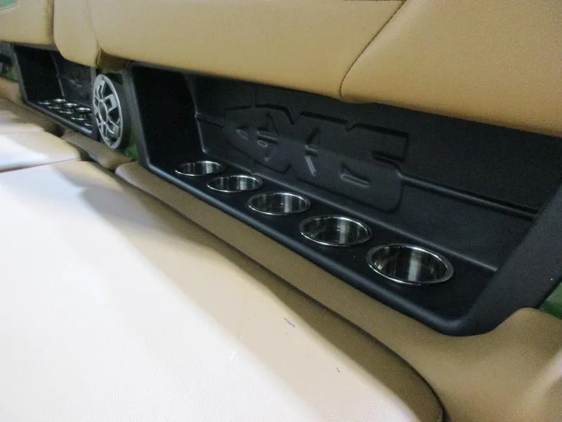 Slide: The Image of 2023 Axis A24 boat interior with cup holders and speaker. - 9