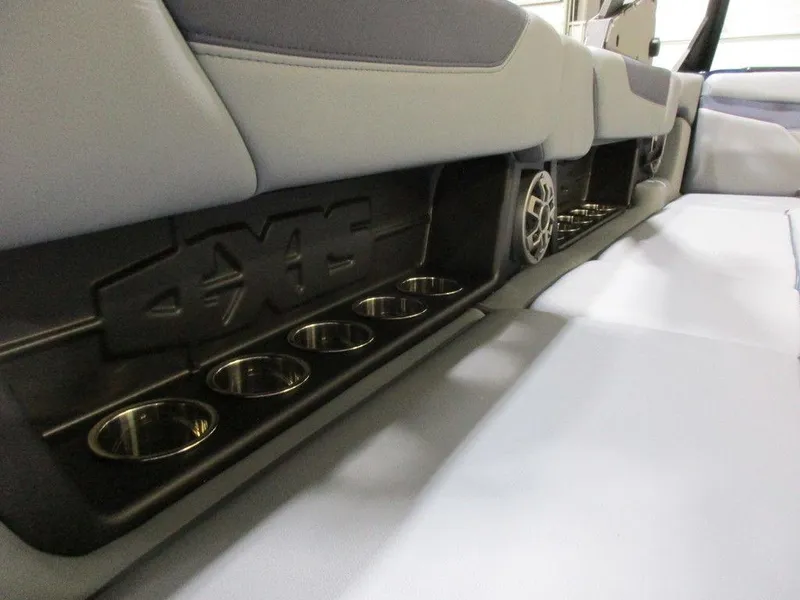 Slide: The Image of 2023 Axis A24 boat interior with cup holders and speaker. - 12