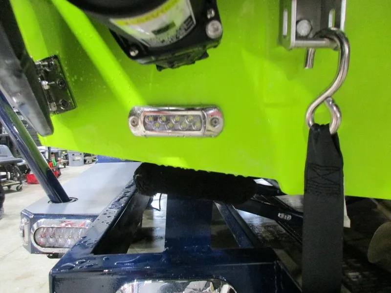 Slide: The Image of 2023 Axis A24 boat on trailer, close-up of rear hull and hardware. - 14