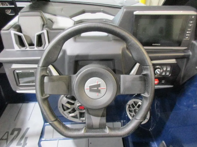 Slide: The Image of 2023 Axis A24 boat dashboard with steering wheel and control panel. - 4