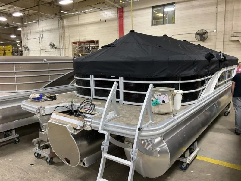 Slide: The Image of 2023 Bennington 23 LSR pontoon boat in a factory setting. - 12