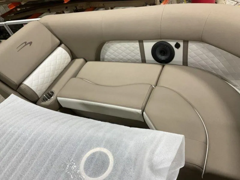 Slide: The Image of 2023 Bennington 23 LSR boat interior with beige and white cushioned seating. - 14