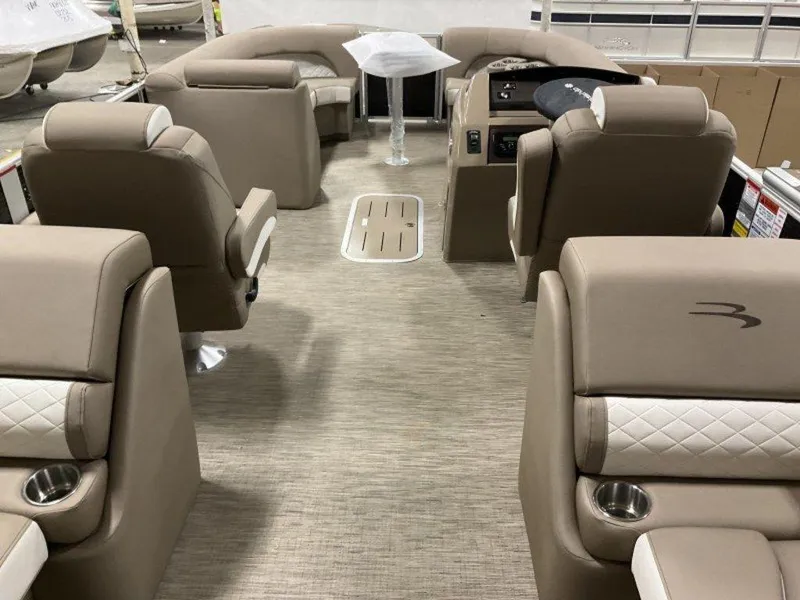 Slide: The Image of 2023 Bennington 23 LSR pontoon boat interior with beige seating and modern design. - 17