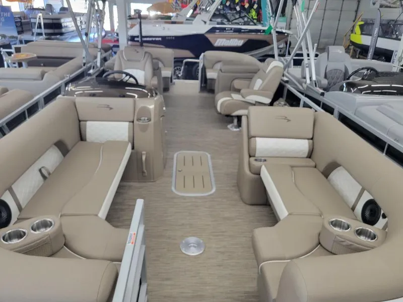 Slide: The Image of 2023 Bennington 23 LSR pontoon boat interior with beige seating and modern amenities. - 2