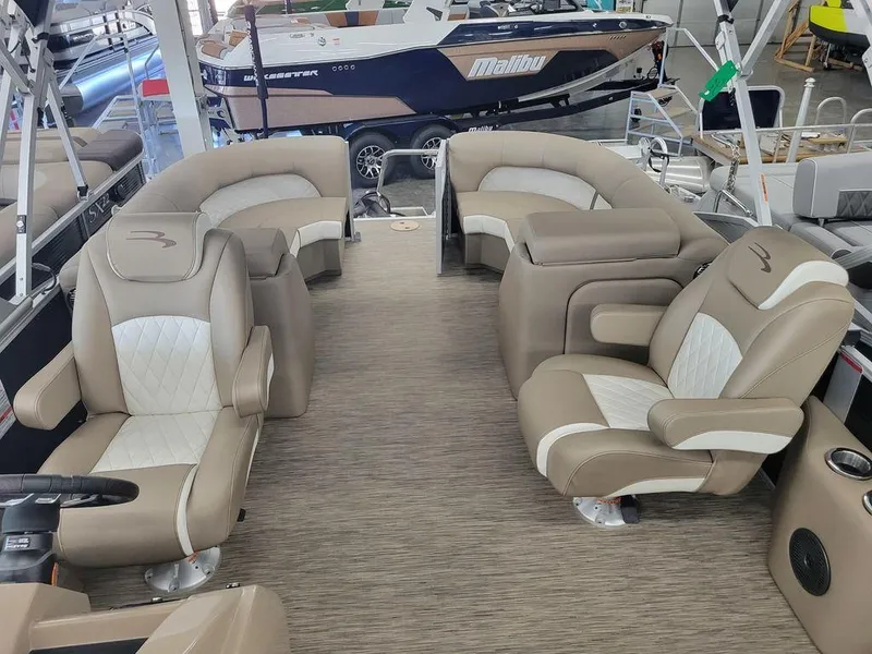 Slide: The Image of 2023 Bennington 23 LSR pontoon boat interior with beige and white seating. - 21
