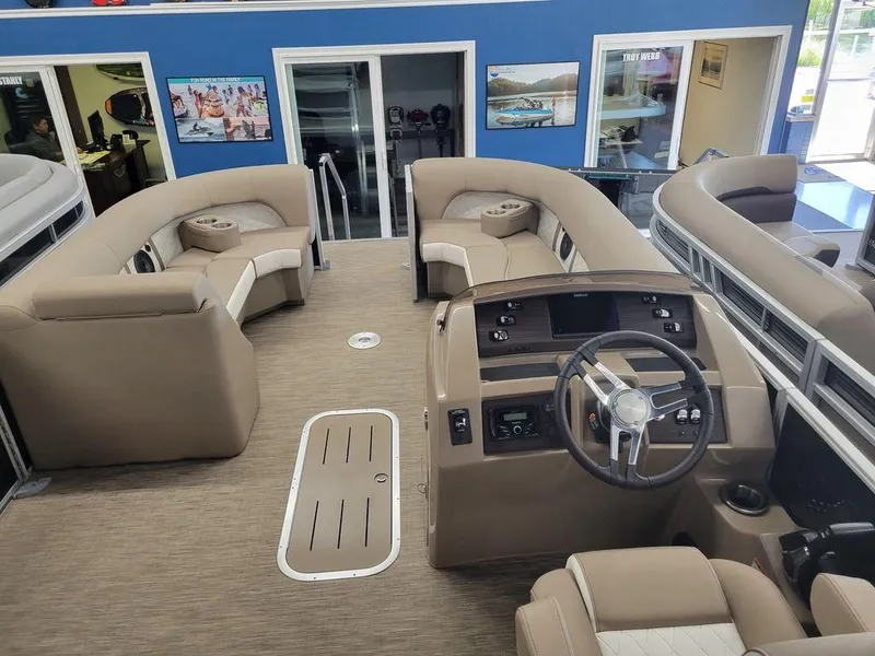 Slide: The Image of 2023 Bennington 23 LSR pontoon boat interior with beige seating and modern helm. - 4