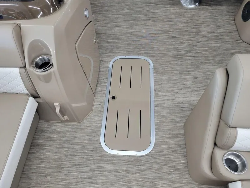 Slide: The Image of 2023 Bennington 23 LSR boat interior with storage compartment and cup holders. - 6