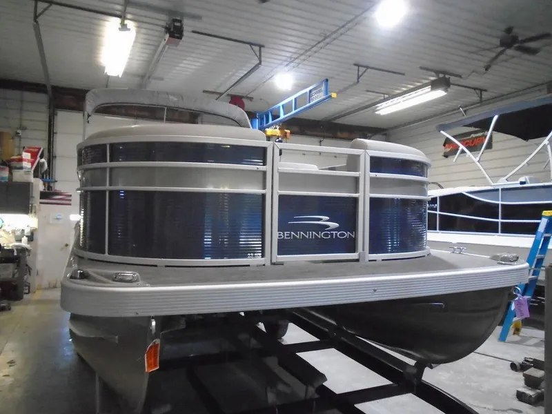 Slide: The Image of 2023 Bennington 23 SXSR pontoon boat in a garage. - 12