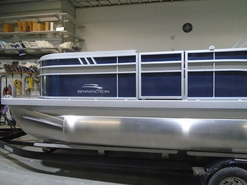 Slide: The Image of 2023 Bennington 23 SXSR pontoon boat in a storage facility. - 2