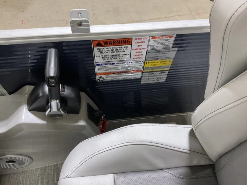 Slide: The Image of Control panel and seat of 2023 Bennington 23 SXSR boat with warning labels. - 21