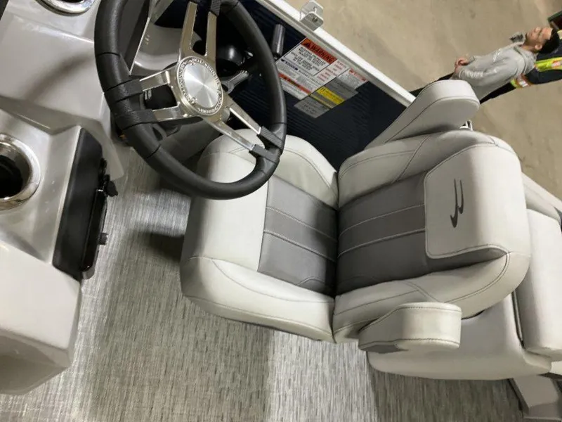 Slide: The Image of 2023 Bennington 23 SXSR boat interior with steering wheel and captain's chair. - 5