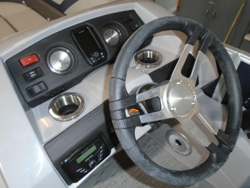 Slide: The Image of 2023 Bennington 23 SXSR boat dashboard with steering wheel and control panel. - 8