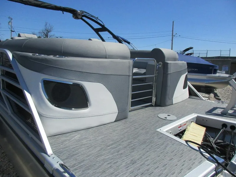Slide: The Image of 2023 Bennington 24 LXFBA pontoon boat with gray seating and deck. - 14