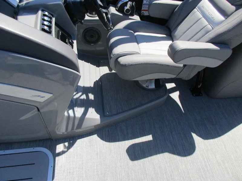 Slide: The Image of 2023 Bennington 24 LXFBA boat interior with captain's chair and control console. - 7