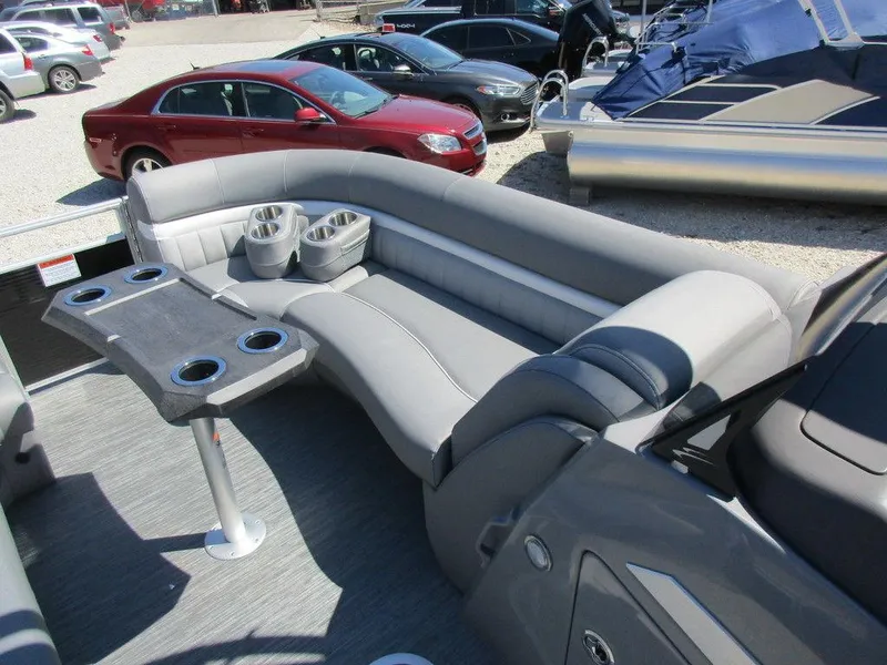Slide: The Image of 2023 Bennington 24 LXFBA boat interior with gray seating and cup holders. - 8
