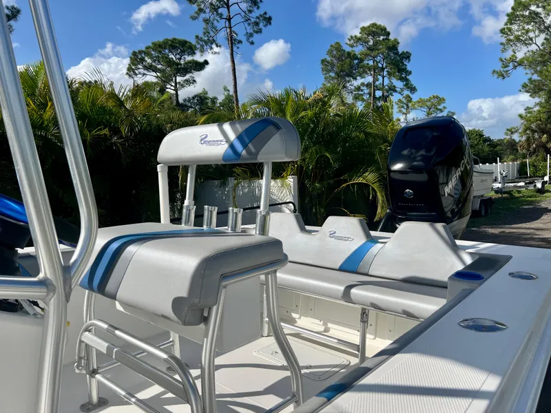 Slide: The Image of 2016 Renegade 250 boat with seating and outboard motor in a tropical setting. - 16