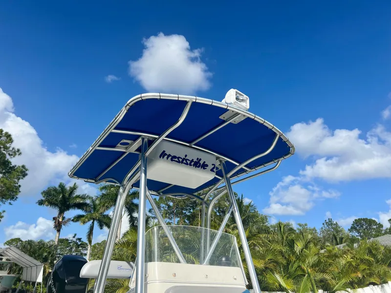 Slide: The Image of Renegade 250 boat 2016 model with blue canopy against a clear sky. - 18