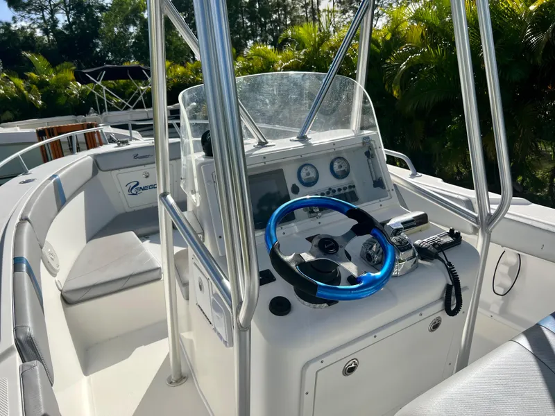 Slide: The Image of 2016 Renegade 250 boat cockpit with steering wheel and control panel. - 21
